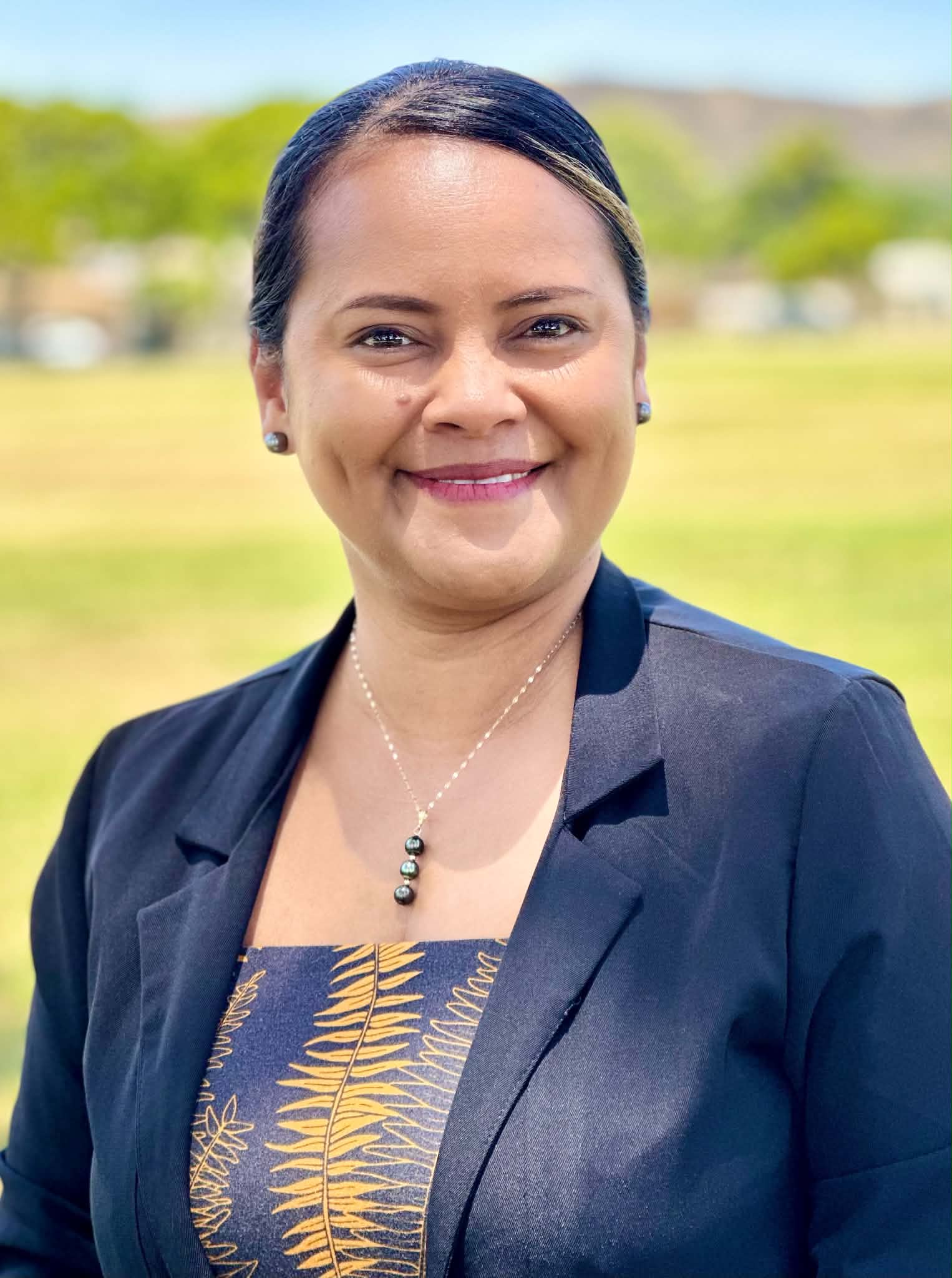 Shanty Sigrah Asher smiling outdoors, candidate for Governor of Kosrae State
